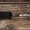 Keychain with a desert landscape design on a wooden surface