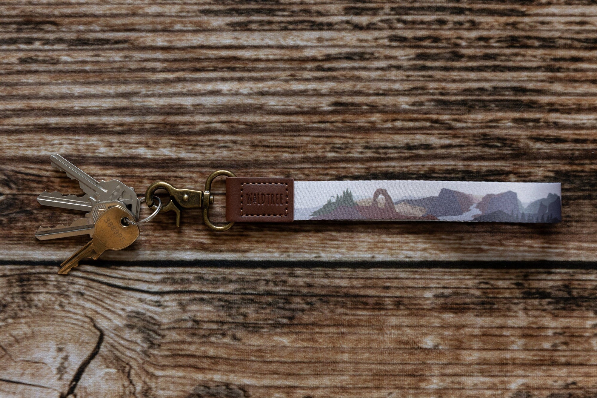 Keychain with landscape design on a wooden surface