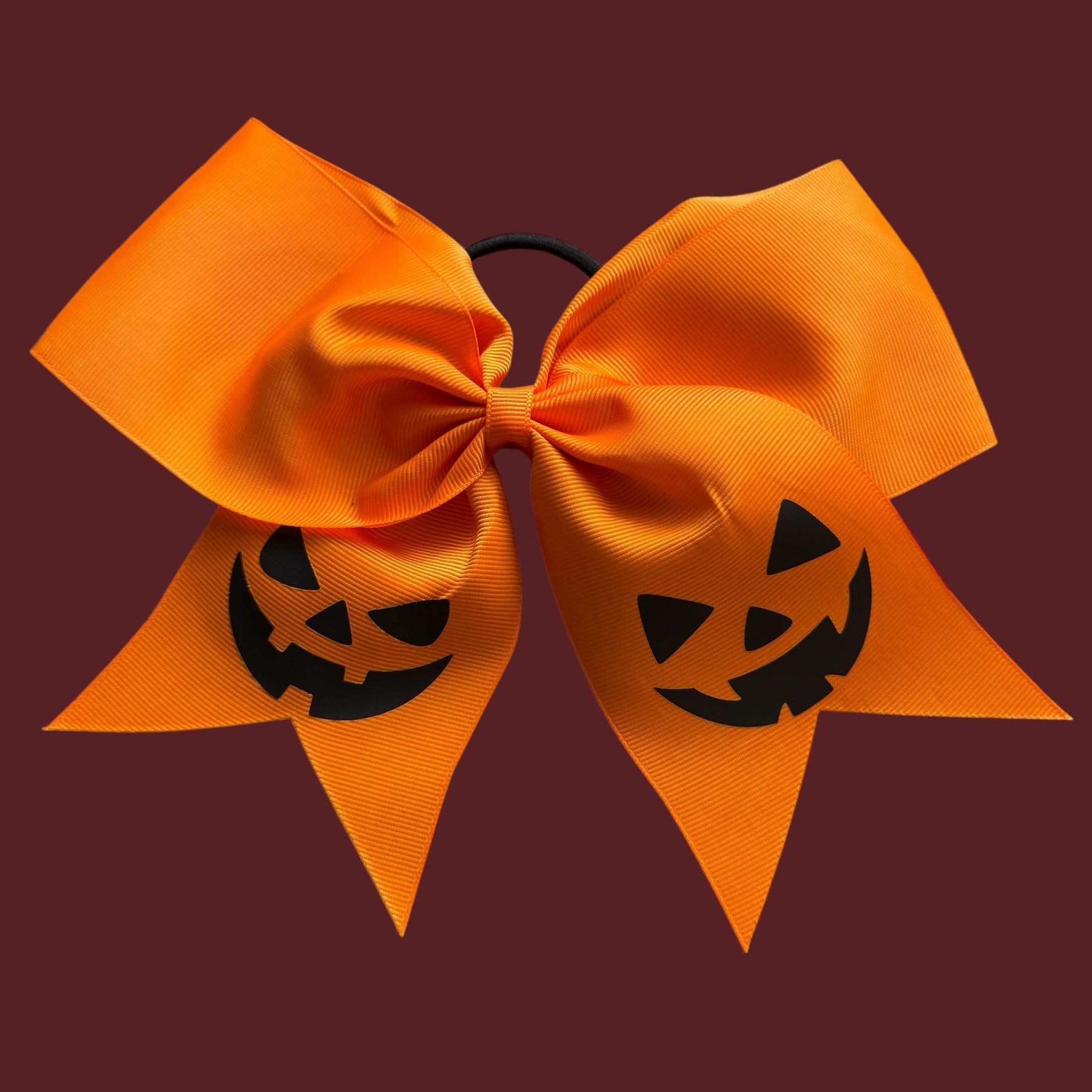 orange bow with pumpkin faces on it, halloween