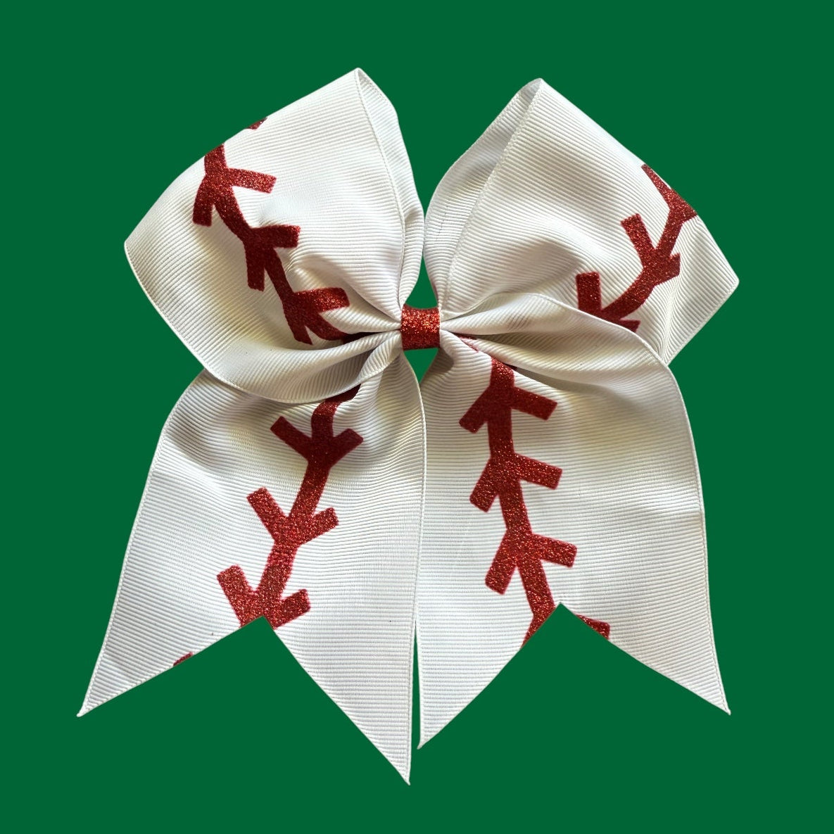 White bow with red baseball patterns on a green background, baseball hairbow, softball hairbow