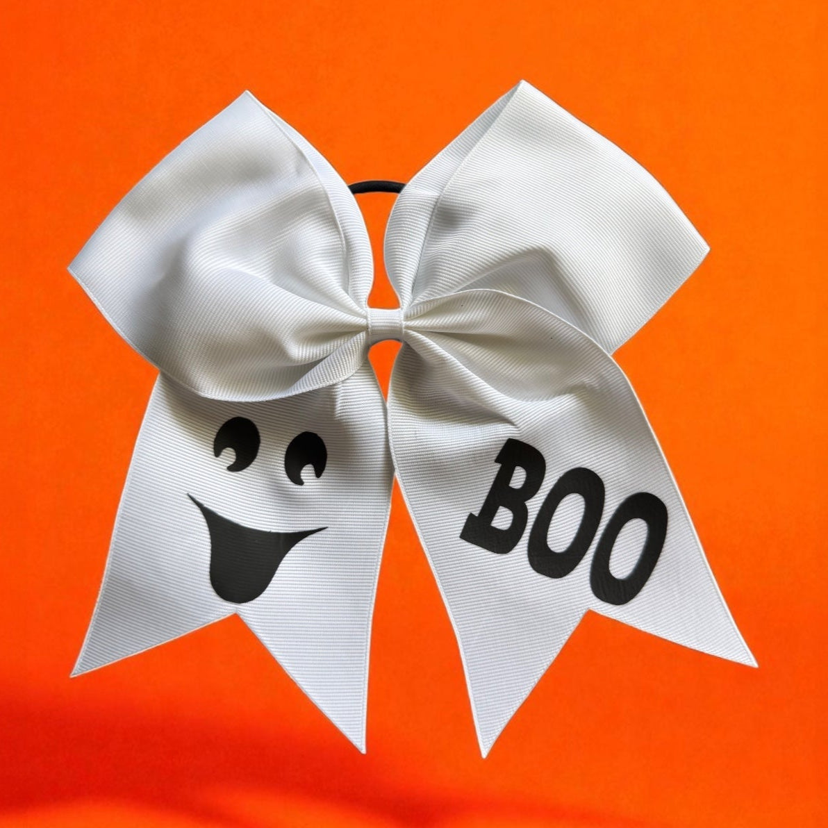 White bow with ghost face and 'BOO' text 